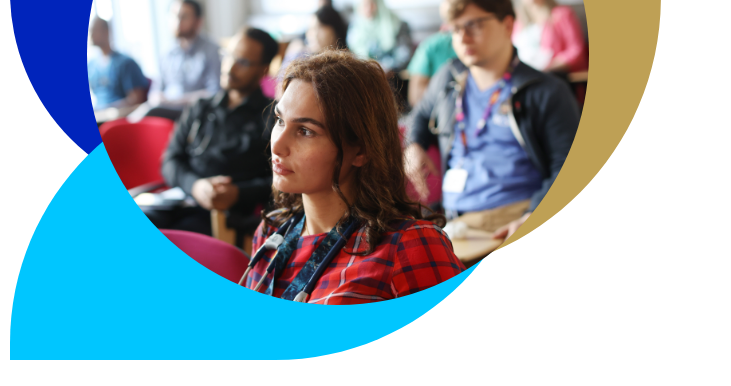 Female doctor in a classroom with others staring straight ahead